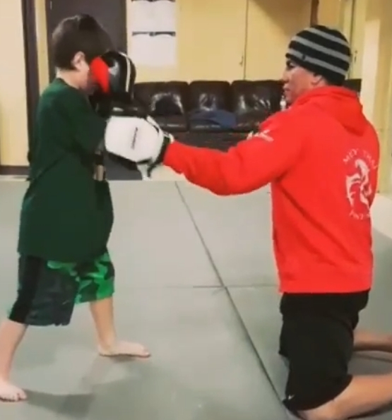 Kru Denis working with a young Muay Thai student
